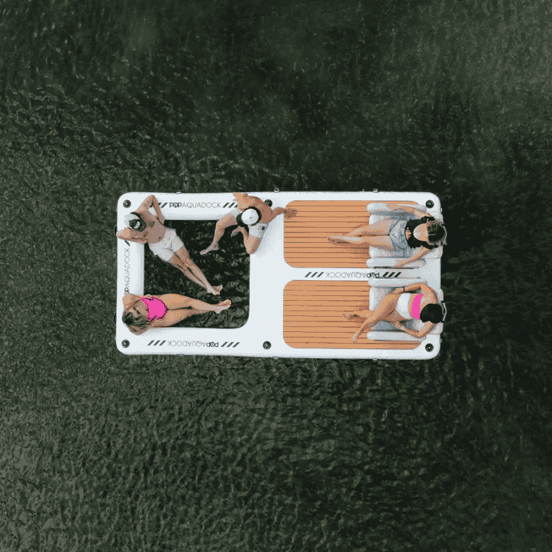 5 People relaxing on a POP AquaDock 14' × 7' Inflatable Floating Dock Platform