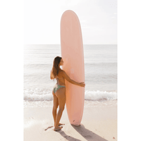 Thumbnail for A Beginner surfer carrying a Surfboard Trading Co. PRIMO EPS Surfboard – Sunset Pink | Versatile Performance Longboard