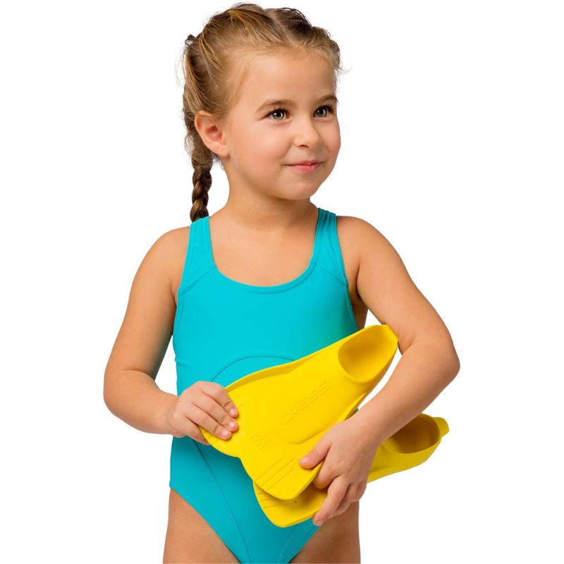 A Child holding a yellow Cressi Mini Light Kids Swimming Fins