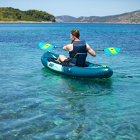 Thumbnail for A man rowing a green Gama Inflatable Kayak
