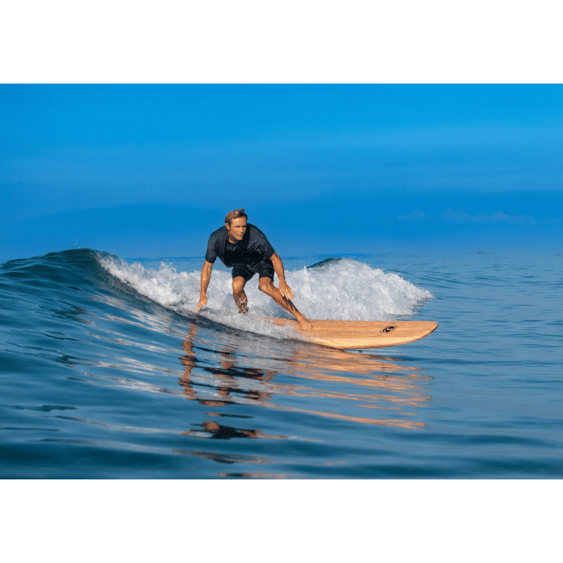 A surfer catching a small wave on a CBC 9' "California 108" Cal Bear Foam Surfboard