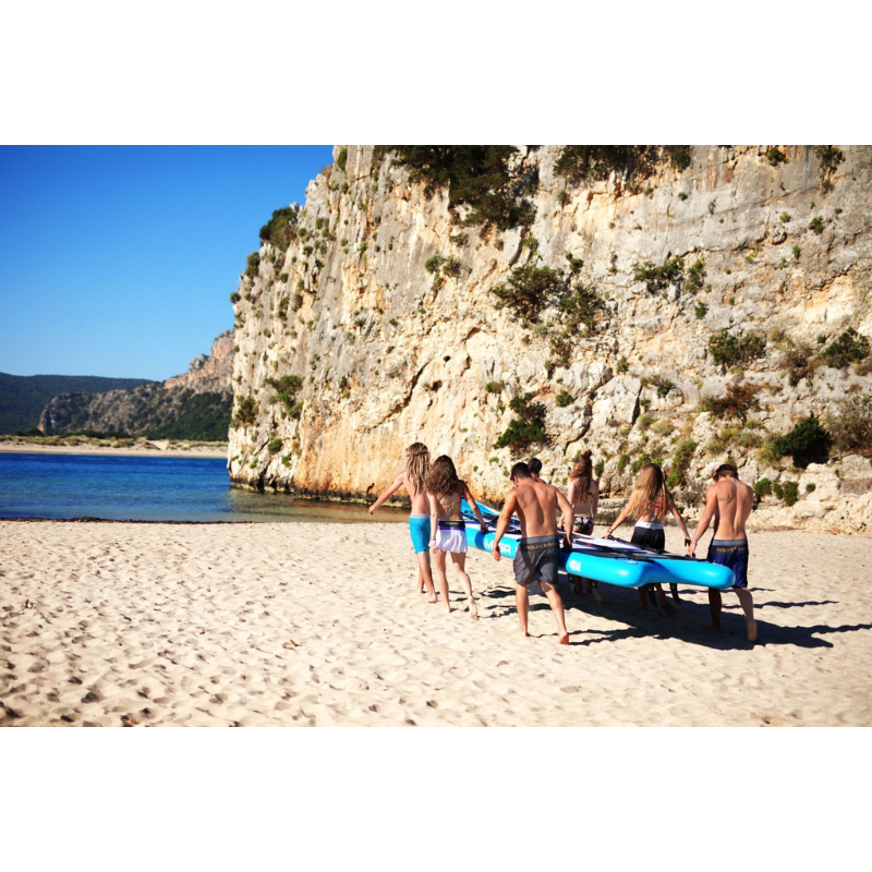 A group of people carrying Aqua Marina 18'1" Mega Inflatable Paddle Board 