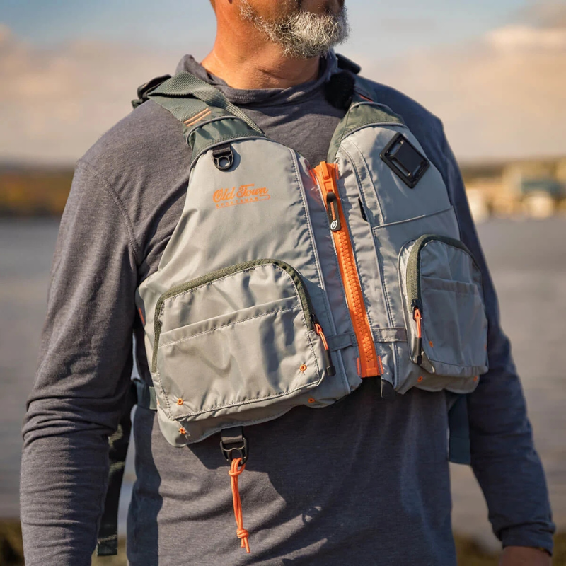 A man wearing Old Town Treble Angler Sportsman Foam Life Jacket - Silver