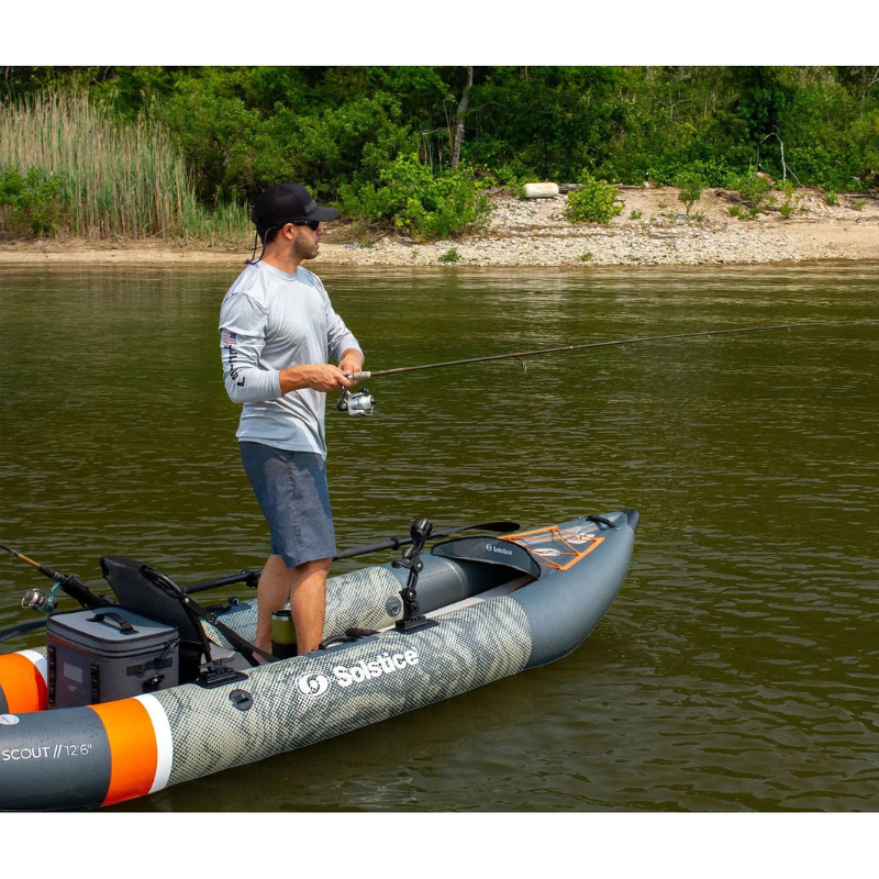 A man standing on Solstice 12'6" Scout 1-2 Person Inflatable Fishing Kayak 