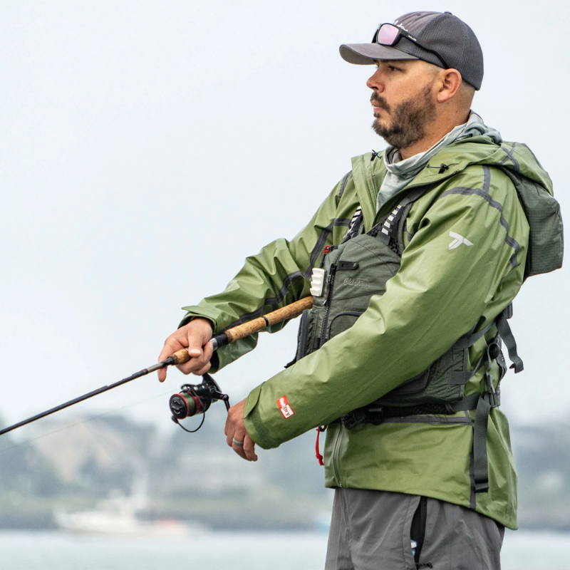 A man wearing Old Town Lure Angler II Men's Foam Life Jacket — Moss