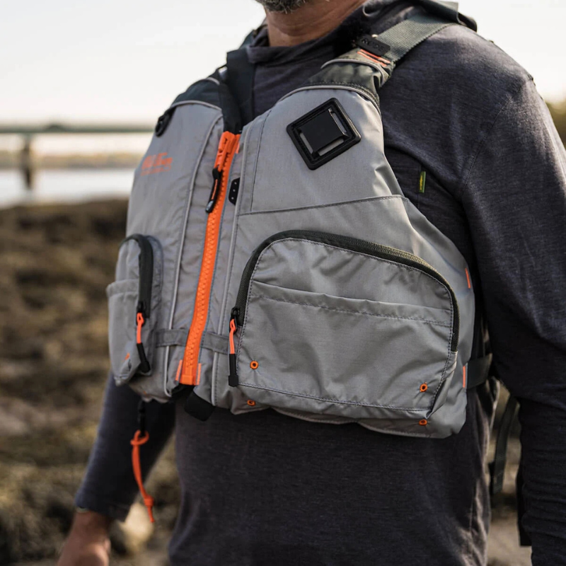 A man in a Old Town Treble Angler Sportsman Foam Life Jacket - Silver