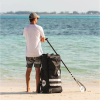 Thumbnail for A man with a bag carrying Pop 10'6 Royal Hawaiian Palm tree iSUP
