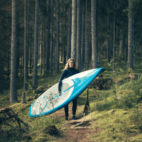 Thumbnail for An Woman carrying a SUP and a Challenge 85 Stand-Up Paddle
