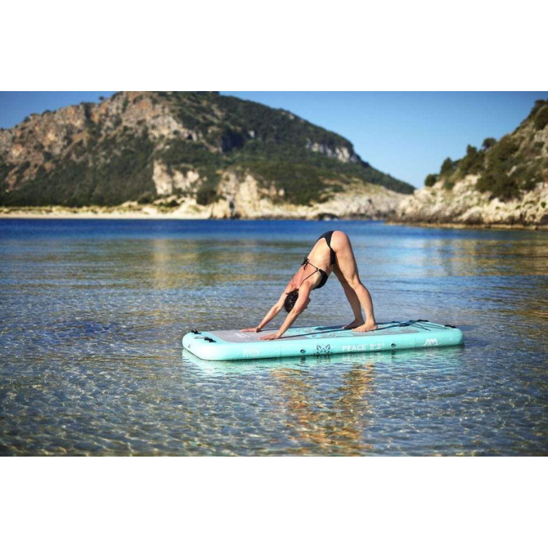 An Woman doing yoga on Aqua Marina 8’2” Peace 2020 Fitness Inflatable Floating Yoga Mat