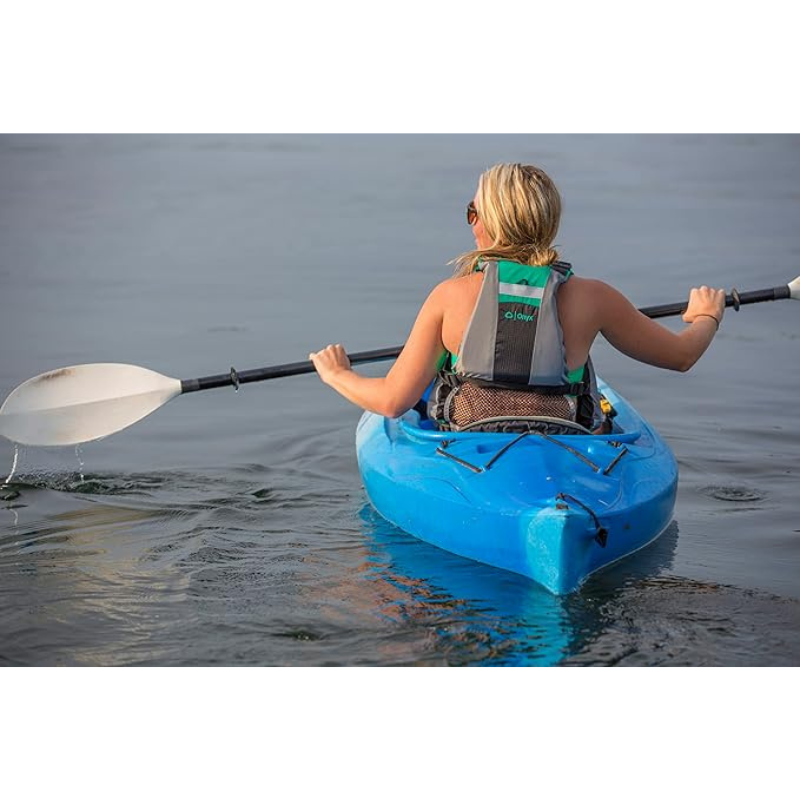 An Woman riding a kayak wearing Onyx MoveVent Dynamic Foam Life Jacket 