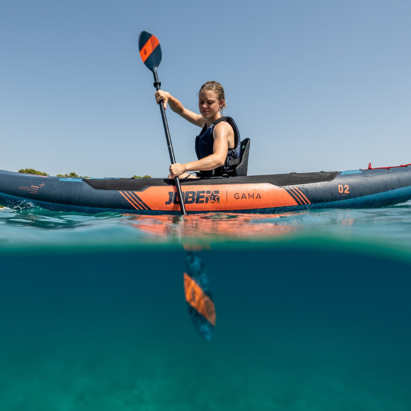 An woman rowing a Gama Inflatable Kayak Teal