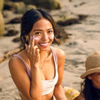 Thumbnail for An woman applying Badger SPF50 Adventure Mineral Sunscreen Cream on her face