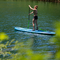 Thumbnail for An woman on her Jobe Aero Yarra 10’6” Inflatable Paddle Board iSUP – Steel Blue