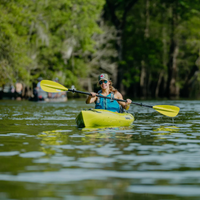 Thumbnail for An woman on her kayak with an yellow Bending Branches Sunrise Glass 2‑Piece Kayak Paddle 