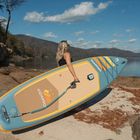 Thumbnail for A person carrying Badfish 11' Monarch 2026 Inflatable Paddleboard | All-Around SUP 
