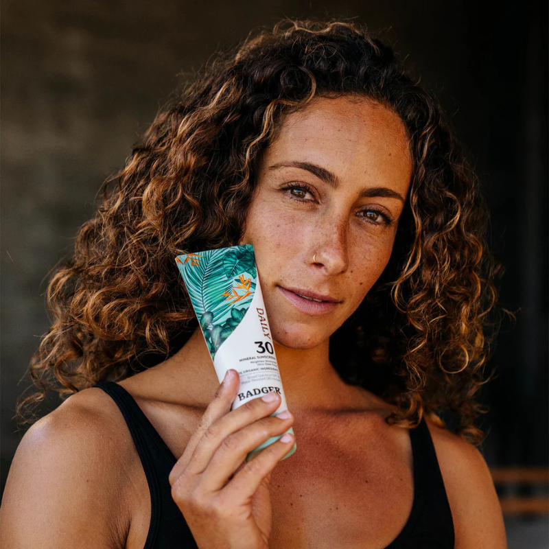 A person holding Badger SPF30 4 fl oz (118 ml) Daily Mineral Sunscreen