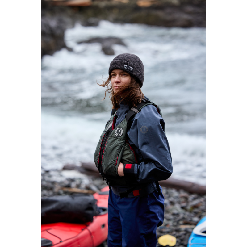A person in Mustang Survival L/XL Rebel Women's Foam Life Jacket - Grey vest