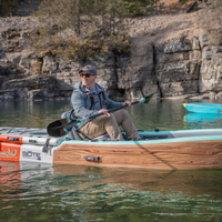 Thumbnail for A person riding Onyx MoveVent Dynamic Foam Life Jacket – Orange