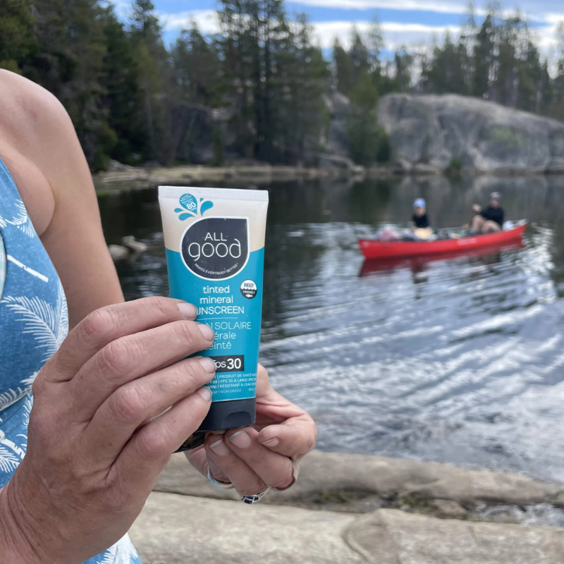 A person showing All Good SPF30 Tinted Mineral Sunscreen