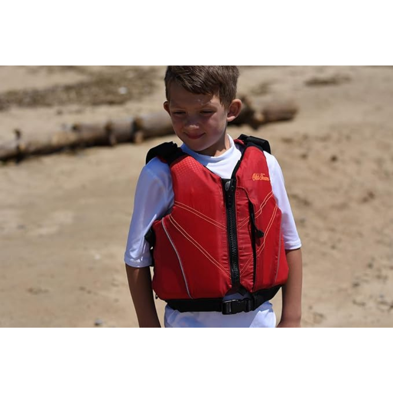 A young boy wearing a Old Town Inlet Jr Kids' Foam Life Jacket – Red