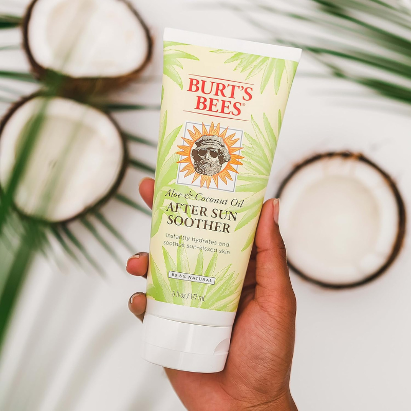 Burt’s Bees 6 oz Aloe & Coconut Oil After Sun Soother Lotion being held by a person