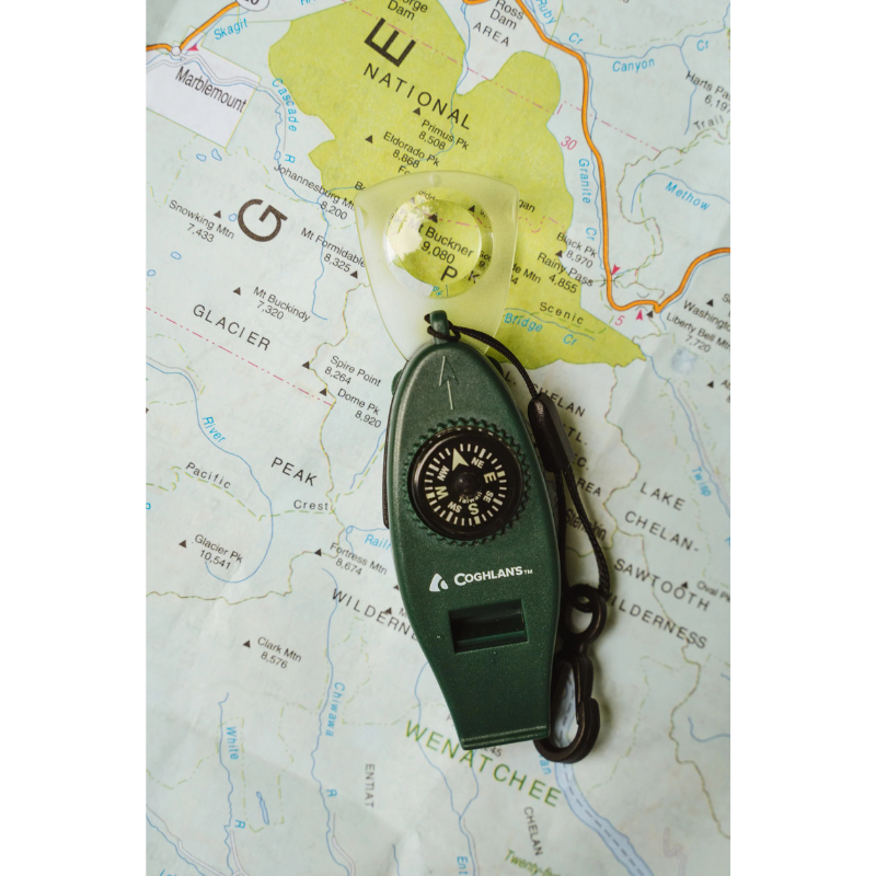 Coghlan's Six Function Whistle/Compass/Thermometer Multi-Tool - Green on a man