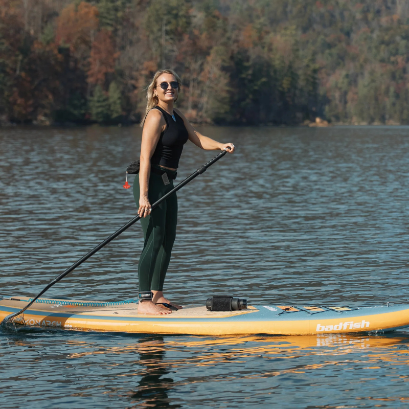 Lifestyle Photo of a person riding a Badfish 11' Monarch 2026 Inflatable Paddleboard | All-Around SUP 