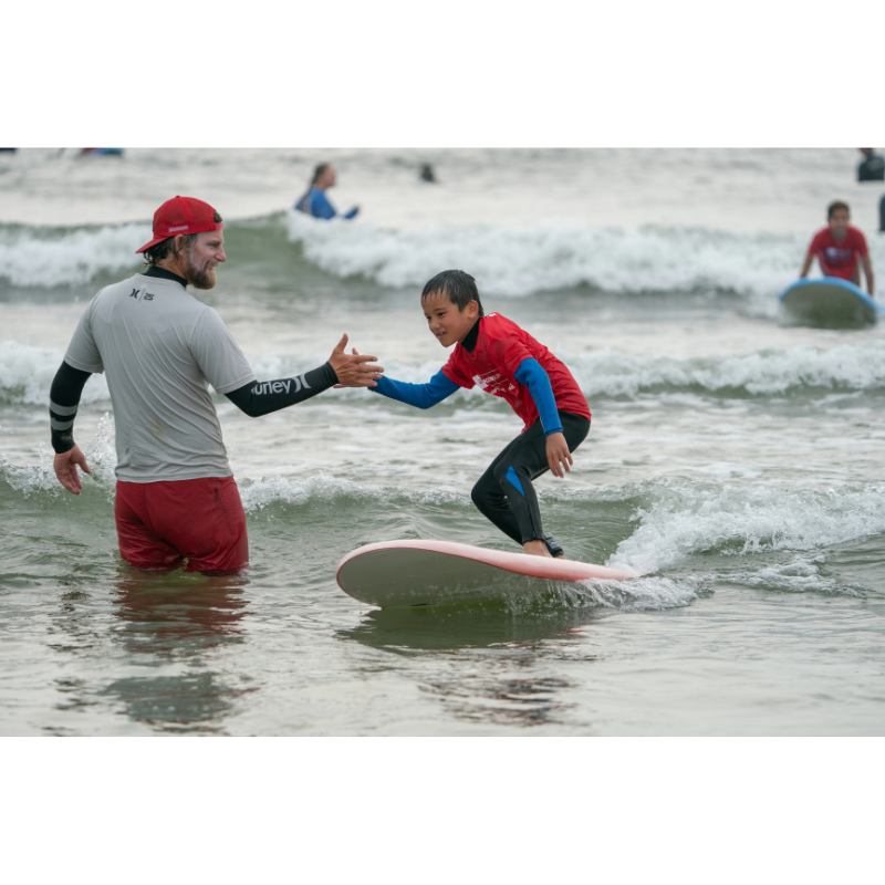 Lifestyle photo of Liquid Shredder Blackball Beater 4'11" (EZ-Slider) Soft-Top Surfboard – Red 