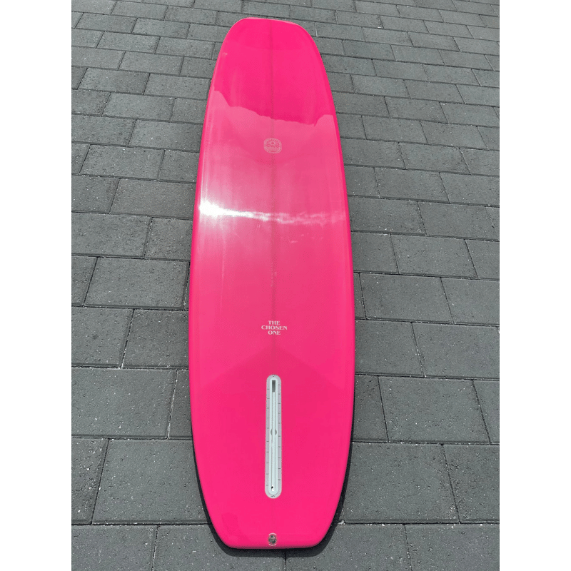 Lifestyle photo of a Surfboard Trading Co. Chosen One Noserider Surfboard – Hot Pink Longboard Bottom