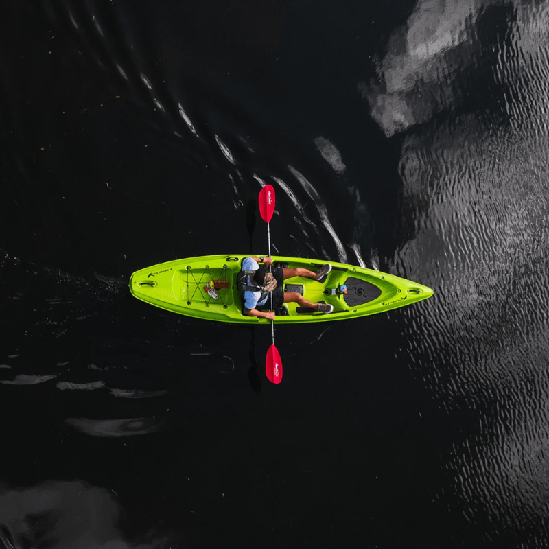 Overhead view of a person in a kayak using Manta Ray Fiberglass 2-Piece Snap-Button Kayak Paddle