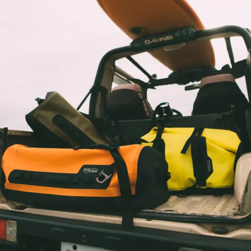 SealLine PRO Zip 40L Dry Duffle Bag Orange on the back of a car
