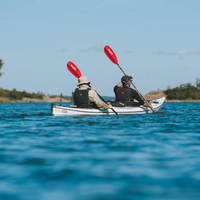 Thumbnail for A person rowing a kayak with Sting Ray Hybrid 2-Piece Posi-Lok Kayak Paddle Red