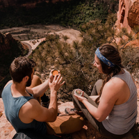 Thumbnail for Two people using Badger Sore Muscle Rub Tin - Natural & Organic