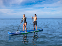 Thumbnail for Two people effortlessly balance on an inflatable paddle board