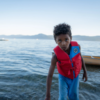 Thumbnail for a child wearing Mustang Survival Rev Youth Foam Life Jacket