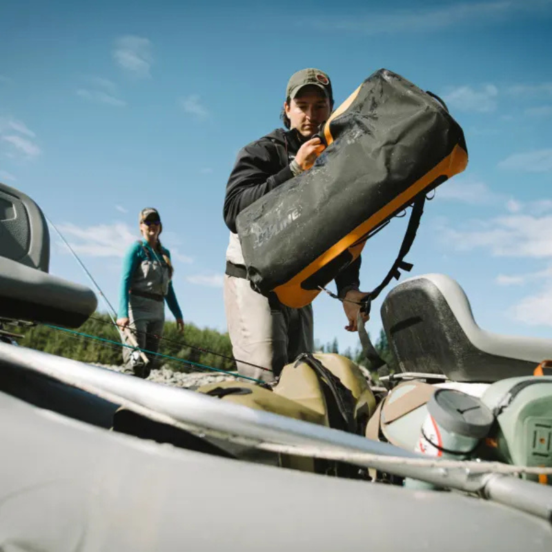 a man carrying an orange SealLine PRO Zip 40L Dry Duffle Bag