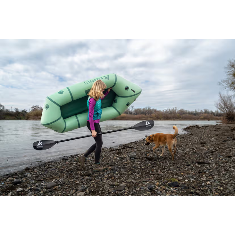 a person carrying Kokopelli XPD boat Sage with her dog