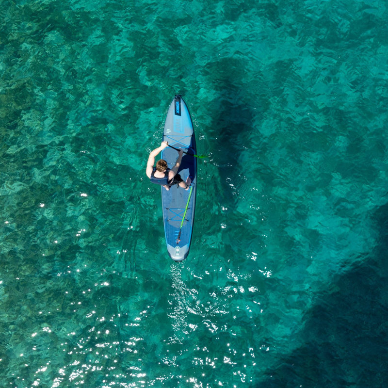 a person riding Jobe Aero Duna 11’6” Inflatable Paddle Board iSUP Blue