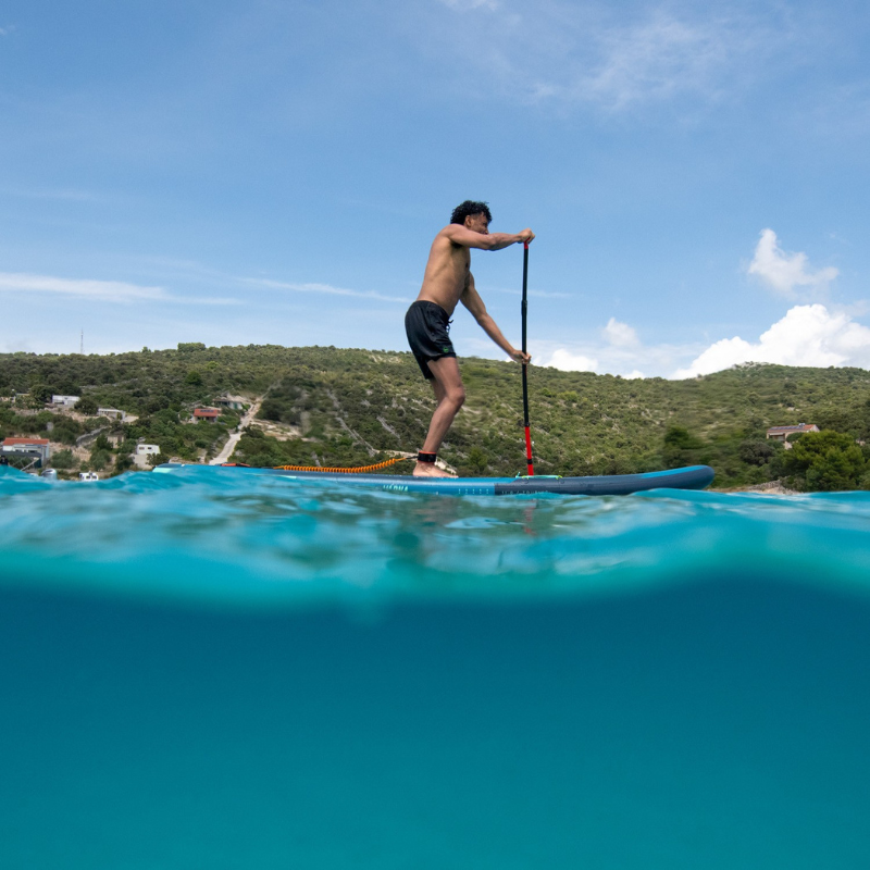 a person riding Jobe Aero Varna 11’ Inflatable Paddle Board