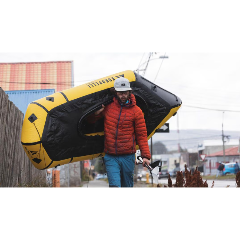 man carrying Kokopelli Rogue yellow R-Deck Packraft w/ TiZip 