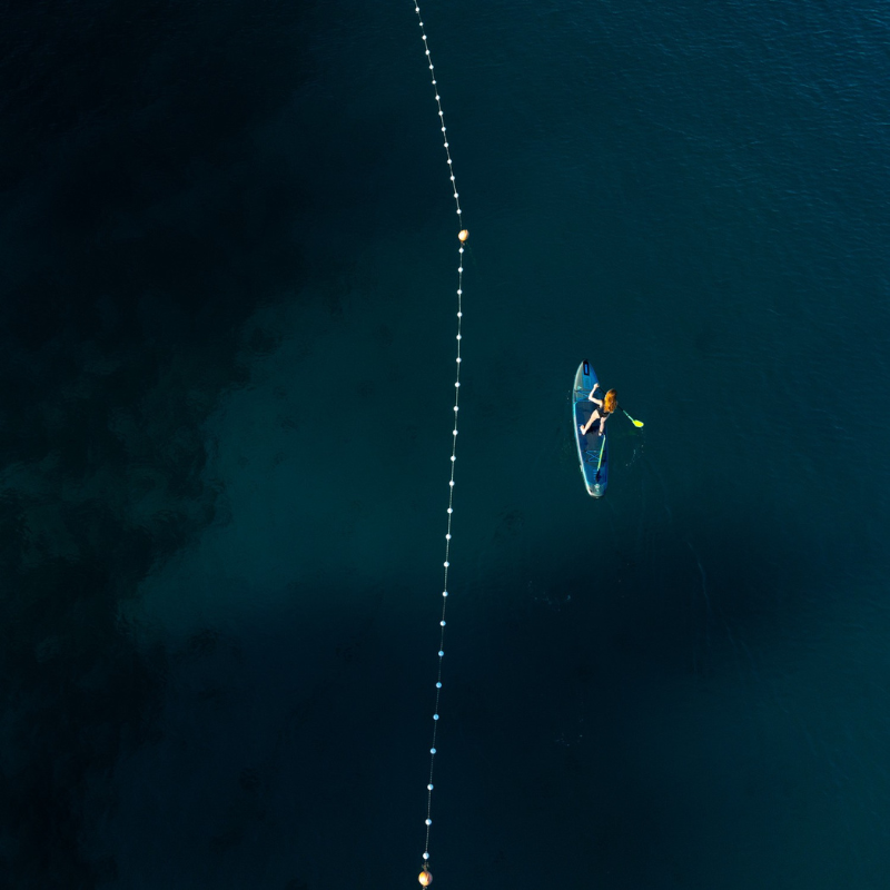 overhead view of a person riding Jobe Aero Duna Inflatable Paddle Board iSUP – Blue