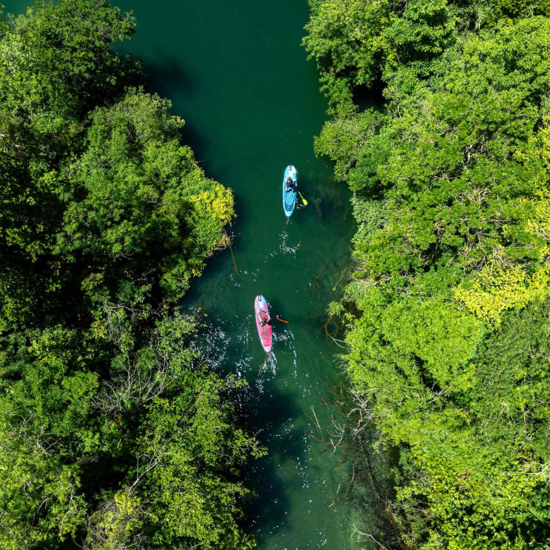 overhead view of two people riding Jobe Aero Yarra 10’6” Inflatable Paddle Board iSUPs