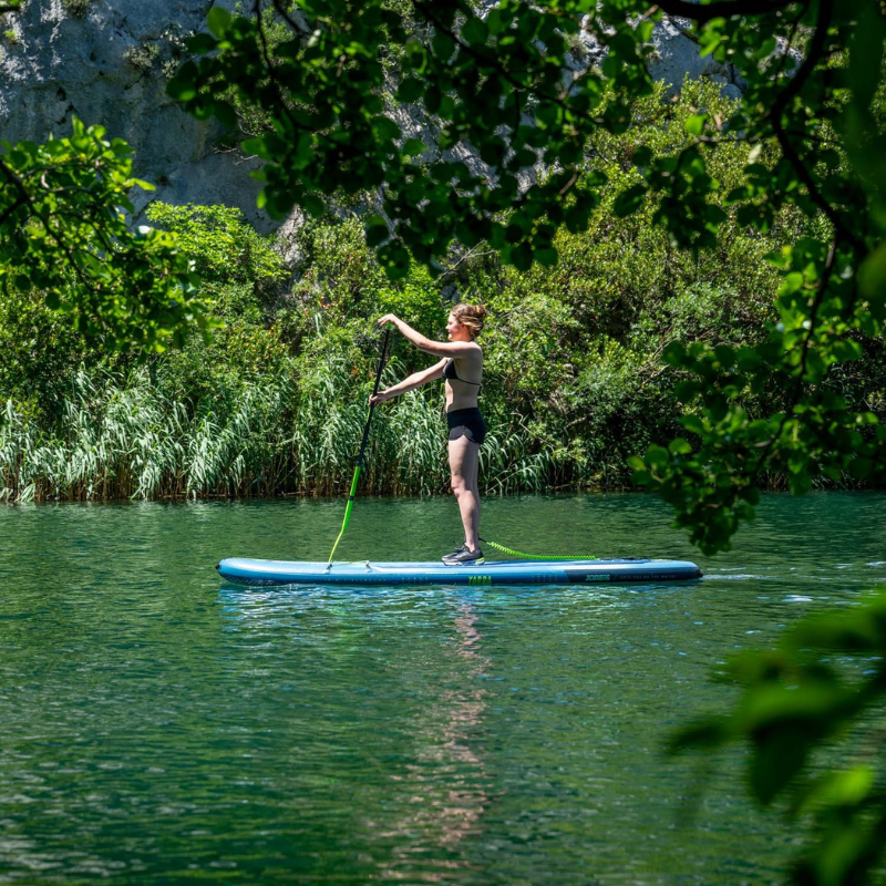 side view of an woman on Jobe Aero Yarra 10’6” iSUP Steel Blue