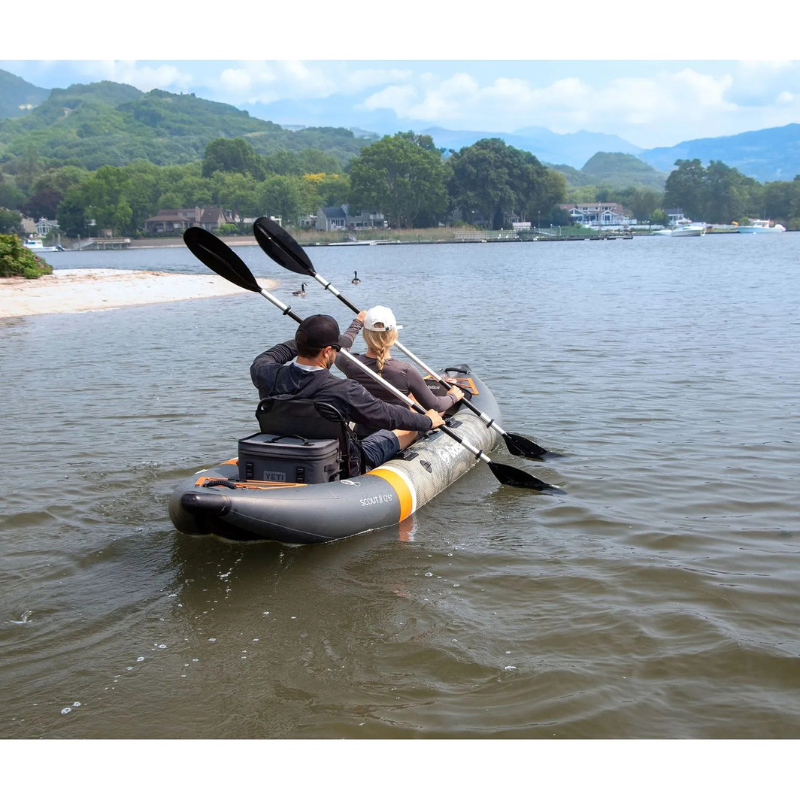 two people using Solstice 12'6" Scout 1-2 Person Inflatable Fishing Kayak in tandem